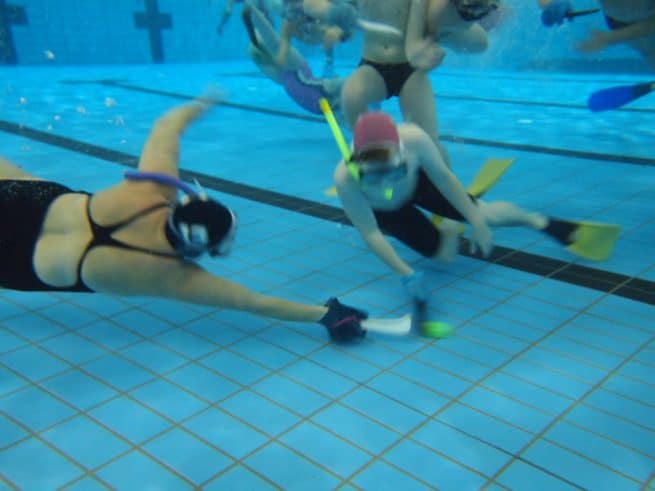 Geelong Underwater Hockey players competing for the puck.